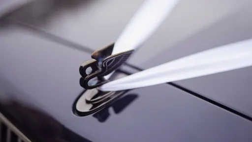 White Ribbons on a blue Bentley Mulsanne over the flying B mascot on the bonnet.