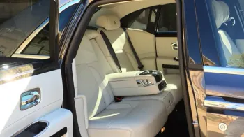 Rear hinged passenger door open showing large legroom and cream leather interior inside Rolls-Royce Ghost