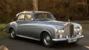 Front right side view of classic Rolls-Royce with Autumn background