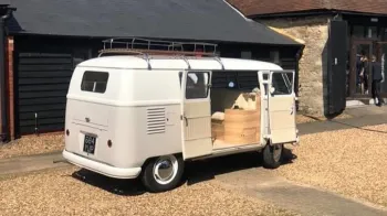 Rear view of Classic VW Campervan with rear passenger double door open
