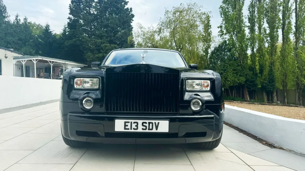 Black Rolls-Royce Phantom full front view with black chrome grill