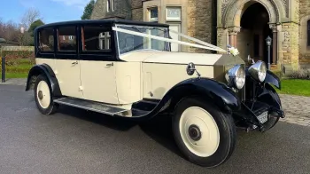 Right side view of Vintage 1930s Rolls-Royce in Black & Ivory dressed with ivory ribbons and bow
