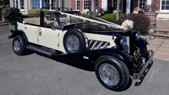 Ivory and Black Beauford Convertible decorated with ivory ribbons and a large bow