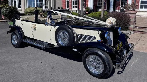 Ivory and Black Beauford Convertible decorated with ivory ribbons and a large bow