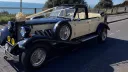 Ivory Beauford Convertible with Black Wheel Arches and Bonnet dressed with Ivory ribbons and a very large bow on top of the front radiator grill