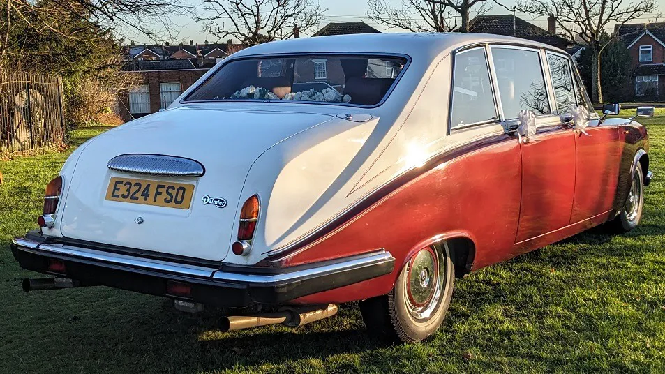 Rear view of Bugundy Daimler Limousine with White Roof