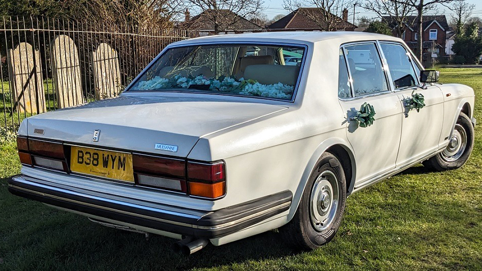 Rear view of White Bentley Mulsanne with Green Bows on the door handles