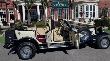 Beauford Convertible with front and rear door open showing cream leather seats and Burgundy carpet