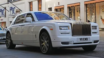 white Rolls-Royce Phantom wth large Chrome front grill and Spirit of Ecstasy sitting atop