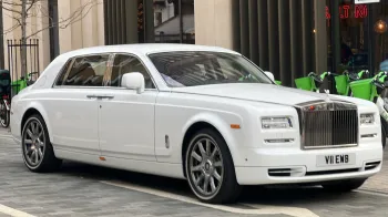 White Rolls-Royce Phantom parked in the Street of London with thin whitewall tires