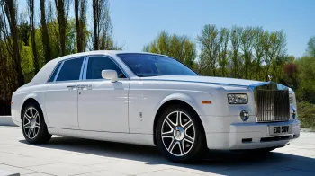 white Rolls-Royce Phantom with chrome alloy wheels
