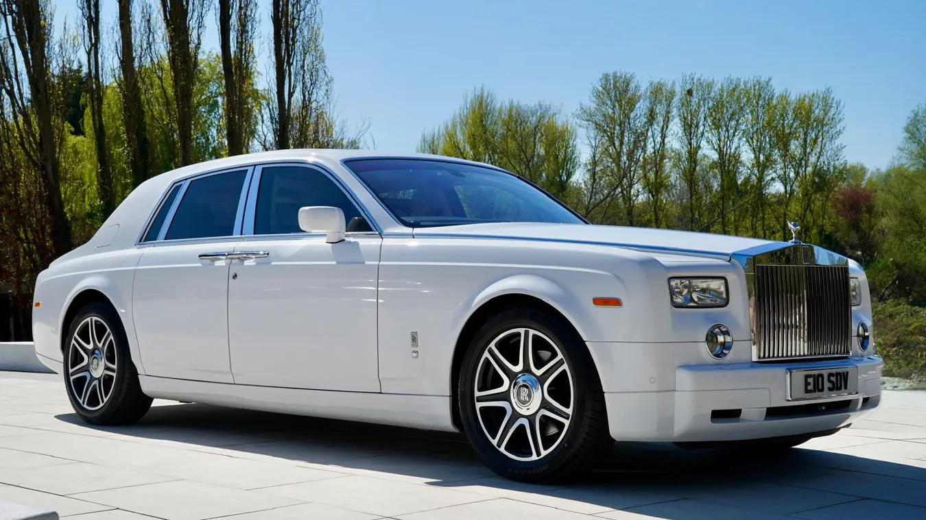 white Rolls-Royce Phantom with chrome alloy wheels