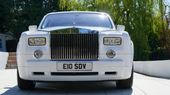 Fill front view of white Rolls-Royce Phantom with large chrome grill and spirit of Ecstasy sitting atop