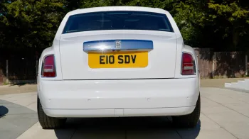 Rear view of White Rolls-Royce phantom with privacy rear window