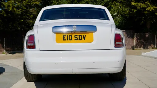 Rear view of White Rolls-Royce phantom with privacy rear window