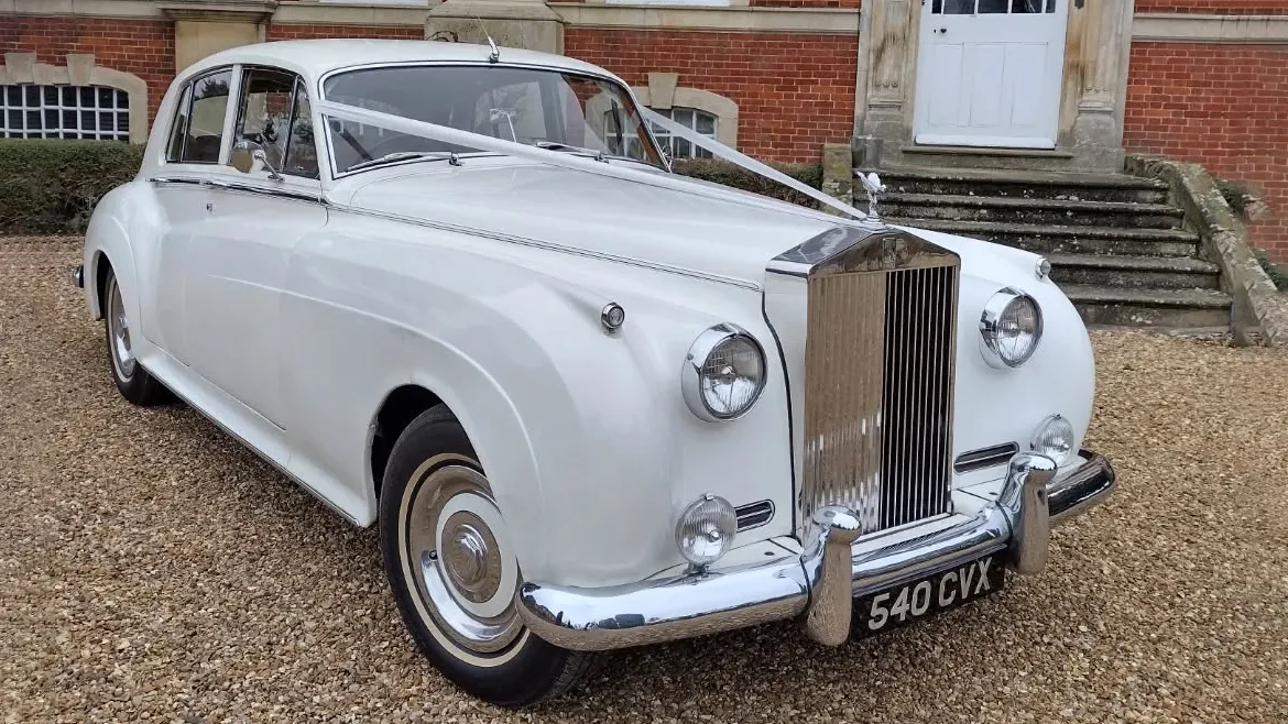 Classic Rolls-Royce Silver Cloud in White with white ribbons across its long bonnet