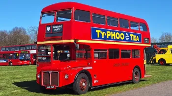 Left side view of Classic Double Decker Red Routemaster bus with Old fashioned advertising on the side.