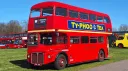Left side view of Classic Double Decker Red Routemaster bus with Old fashioned advertising on the side.