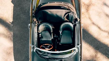 Aerial view of Black Porsche with convertible roof down showing black leather interior