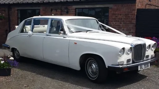 Front right view of Classic Daimler Limousine in Old English white with white ribbons