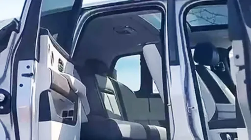 Rolls-Royce cullinan doors open showing a cream leather interior and sunroof