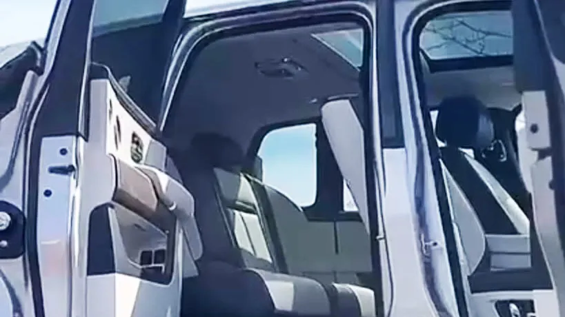 Rolls-Royce cullinan doors open showing a cream leather interior and sunroof