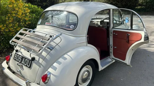 Rear right view of Old Englsih White Classic Morris with rear passenger door open
