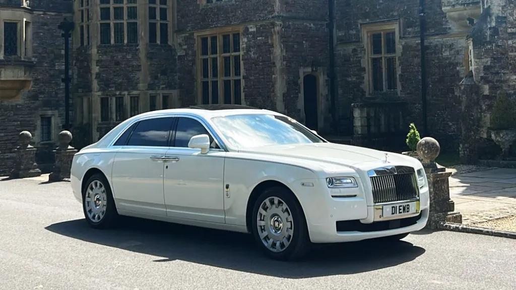 White rolls-Royce Ghost parked in front of rhinefield House Hotel