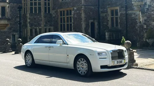 White rolls-Royce Ghost parked in front of rhinefield House Hotel