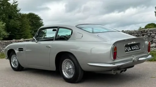 Rear left view of classic Aston Martin DB6 with chrome rear bumper