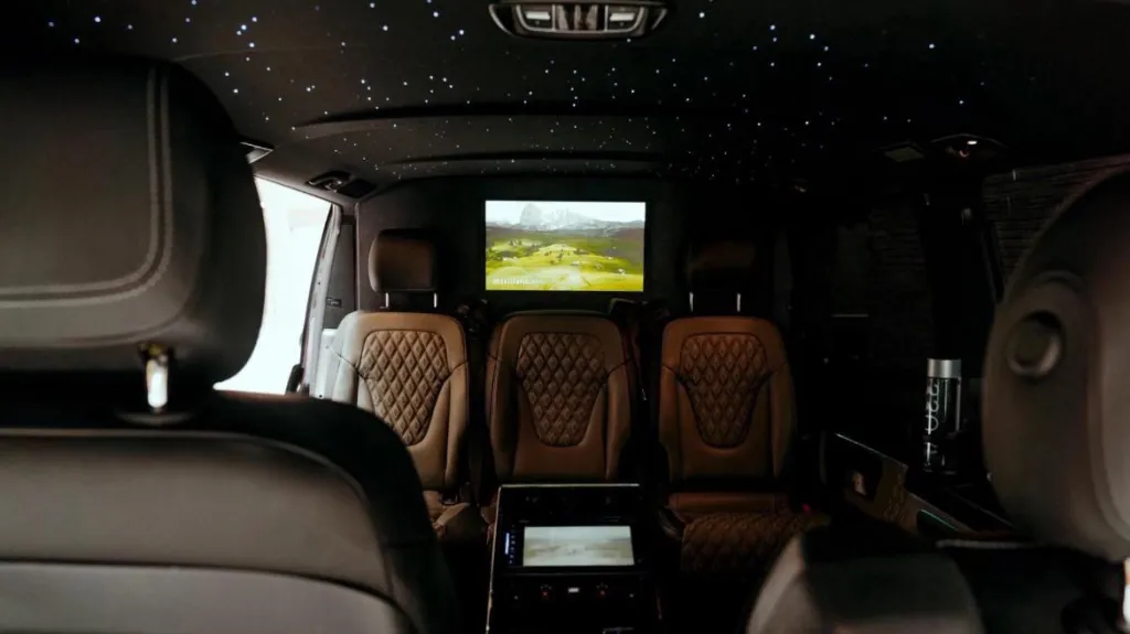 Rear interior inside Mercedes V-class with TV and illuminated starlight roof with blue lights