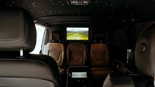 Rear interior inside Mercedes V-class with TV and illuminated starlight roof with blue lights