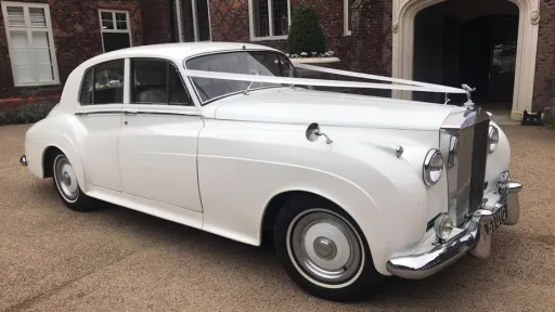 Right side view of classic Rolls-Royce Silver Cloud I with wedding ribbons