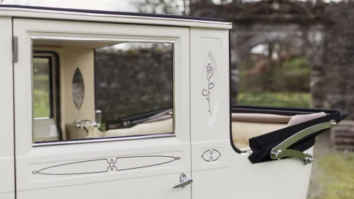 Rear converible roof open in a white imperial wedding car