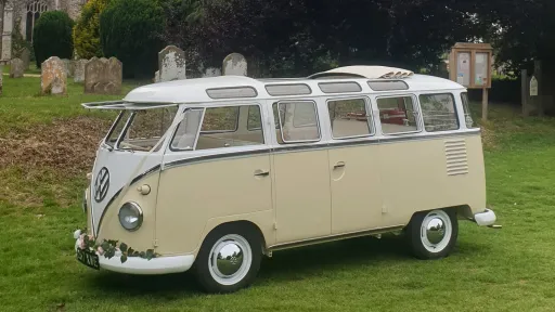 Side view of Classic Volkswagen Campervan in White & Cream with white white wall tires and chrome centre caps.