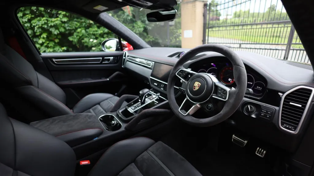 Black Porsche Cayenne GTS front interior seating area from the driver's side