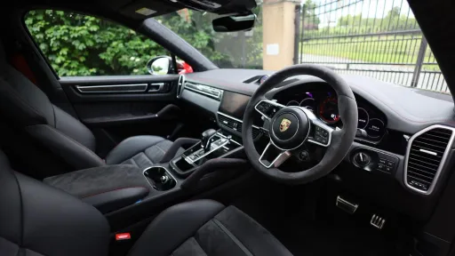 Black Porsche Cayenne GTS front interior seating area from the driver's side