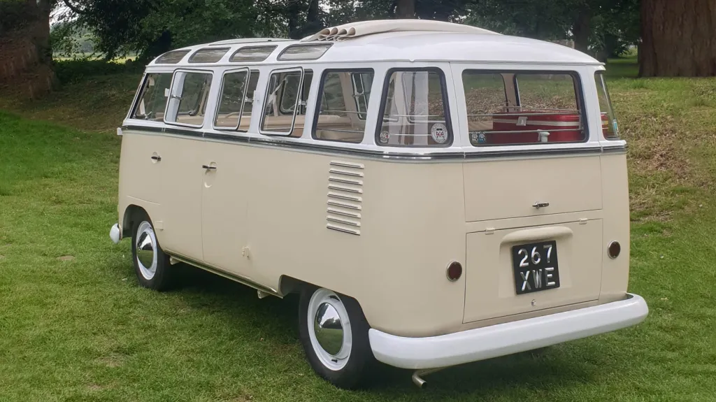 Rear view Classic Volkswagen Campervan in White & Cream with full all-around windows.