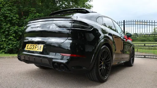 Right side rear view of Black Porsche Cayenne GTS Coupe with black alloy wheels