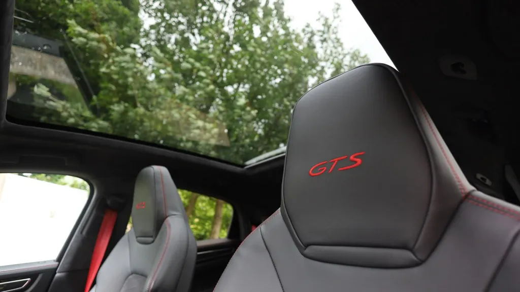 Black Porsche Cayenne GTS panoramic sunroof taken from front passenger seat with front headrest with GTS logo stiched