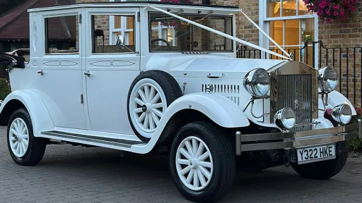 White Vintage-style Imperial Limousine dressed with white wedding ribbons