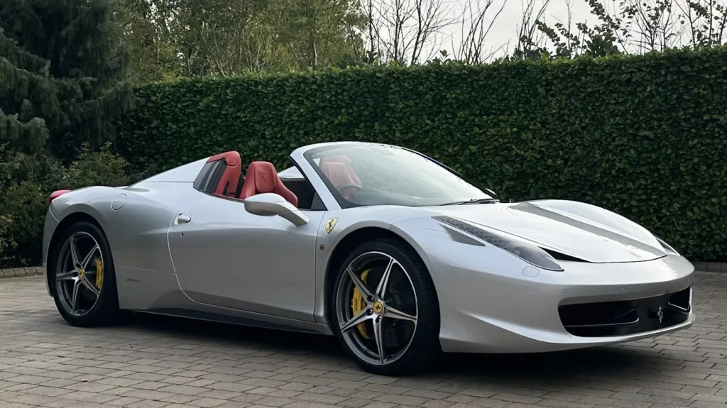 Right side view of a silver Ferrari with convertible roof open