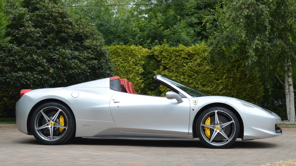 Right side view Ferrari with greenery in the background