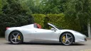 Right side view Ferrari with greenery in the background