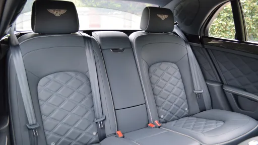 rear interior seats inside Bentley in silver leather abd Bentley logo embroided in the headrest