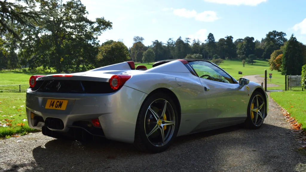 Right rear side view of Ferrari parked in the middle of a path at wedding venue