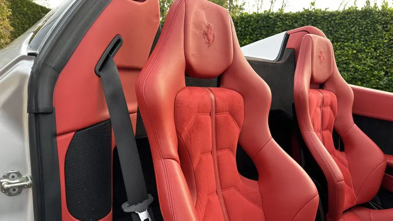 close up view of the red leather sport seats inside Ferrari 458 spider