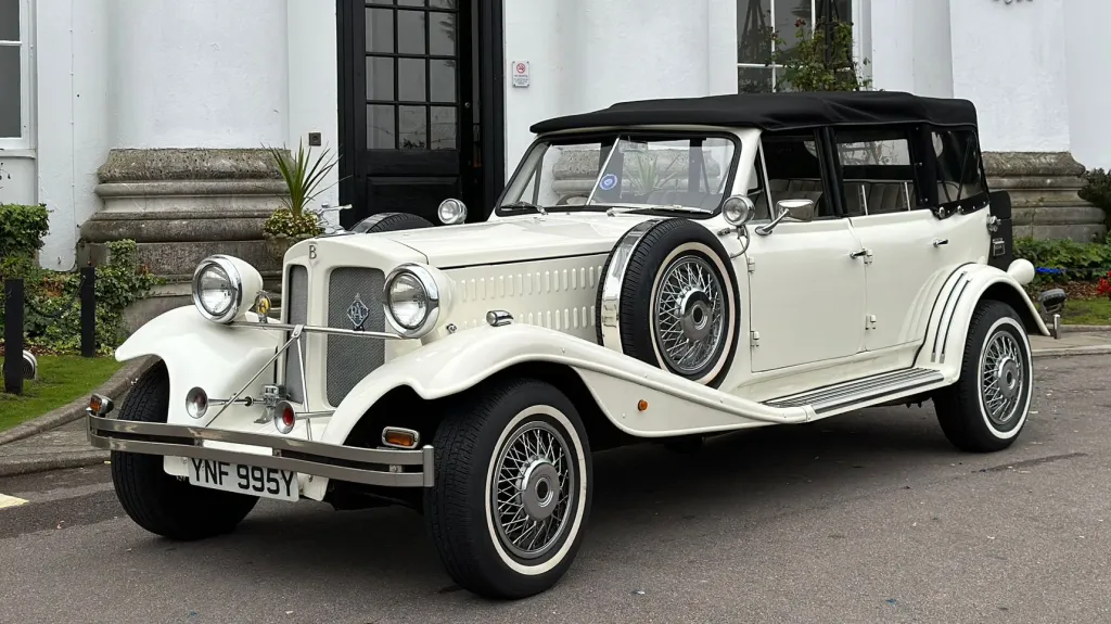 Left side view showing the spare mounted wheel on the wheel arch and Convertible soft top Black roof closed