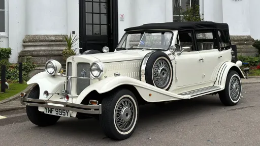 Left side view showing the spare mounted wheel on the wheel arch and Convertible soft top Black roof closed