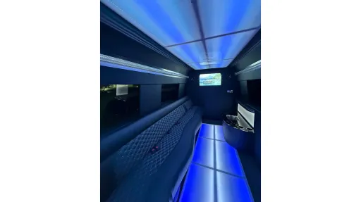 Classic Land Rover in Old English White with white ribbons and spare wheel on front bonnet parked on Devon's beach